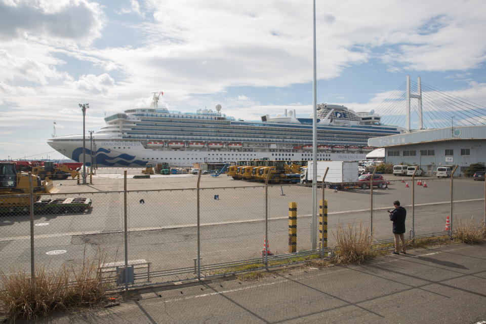  A man takes photos of a Diamond Princess cruise ship at Daikoku Pier in Yokohama. Around 3,600 people are quarantined on board due to fear of spreading the COVID-19 Corona virus, the authorities said, that there has been 39 new infections. (Photo by Stanislav Kogiku / SOPA Images/Sipa USA) 