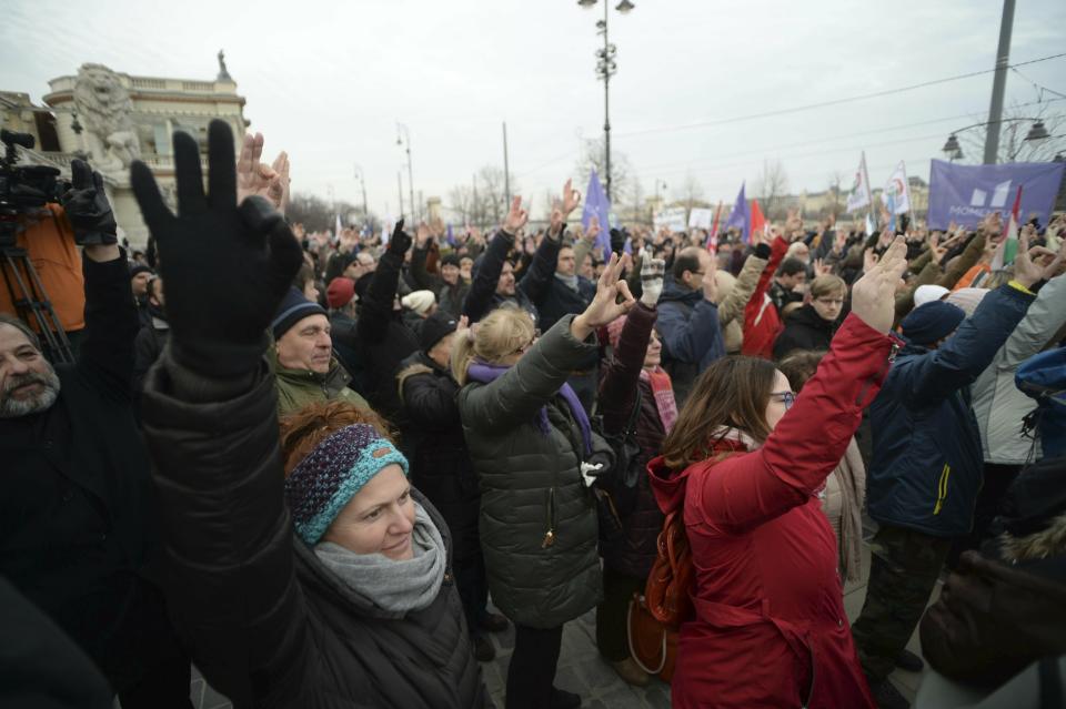 Demonstrators react to a speech during a protest against the recent amendments to the labour code, dubbed 'slave law' by opposition forces, in downtown Budapest, Hungary, Saturday, Jan. 19, 2019. (Zoltan Balogh/MTI via AP)