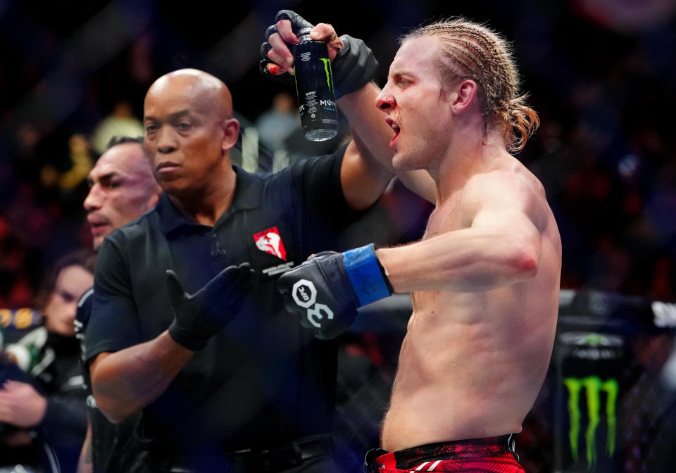Dec 16, 2023; Las Vegas, Nevada, USA; Paddy Pimblett (blue gloves) reacts after defeating Tony Ferguson (not pictured) during UFC 296 at T-Mobile Arena. Mandatory Credit: Stephen R. Sylvanie-USA TODAY Sports