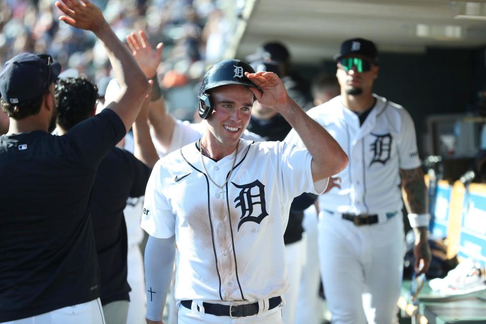 Detroit Tigers right fielder Kerry Carpenter (30) high fives teammates after scoring against the Cleveland Guardians at Comerica Park in Detroit on Saturday, Sept. 30, 2023.
