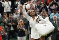 Serena Williams of the US waves as she leaves the court after losing to France's Harmony Tan in a first round women's singles match on day two of the Wimbledon tennis championships in London, Tuesday, June 28, 2022. (AP Photo/Alberto Pezzali)