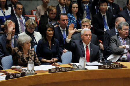 British Prime Minister Theresa May and U.S. Vice President Mike Pence vote to pass a resolution during a meeting of the Security Council to discuss peacekeeping operations during the 72nd United Nations General Assembly at U.N. headquarters in New York, U.S., September 20, 2017. REUTERS/Lucas Jackson