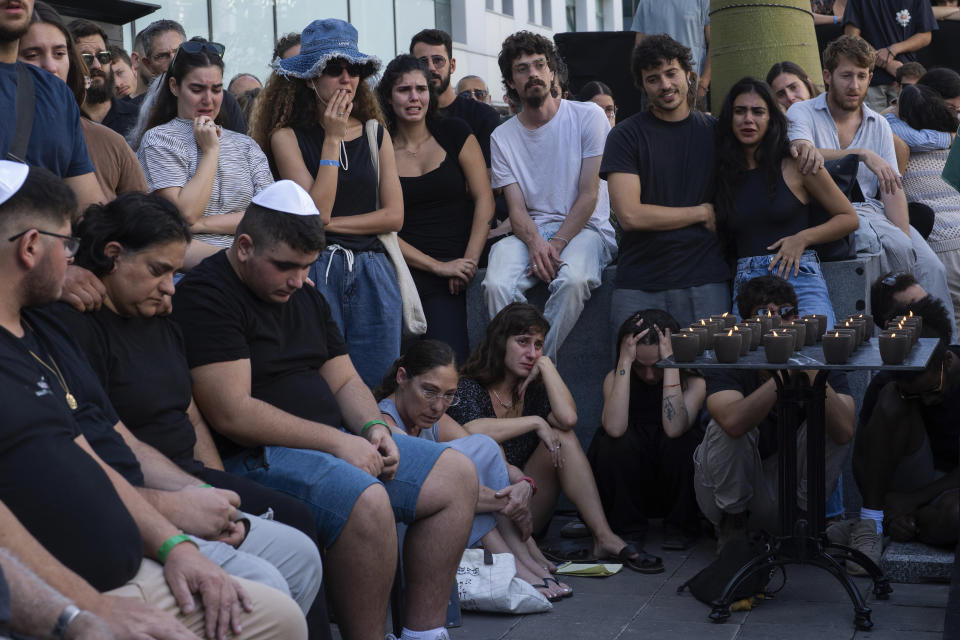 Mourners attend a funeral of the Israeli man Ziv Shapira who was killed by Hamas militants, outside a bar in Tel Aviv, Israel , on Thursday, Oct. 19, 2023. (AP Photo/Petros Giannakouris)