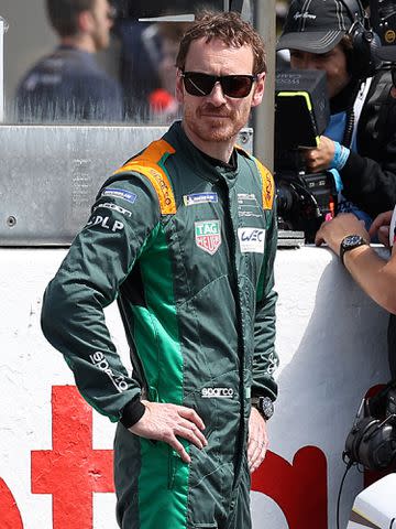 <p>Marc Piasecki/WireImage</p> Michael Fassbender attends the 24 Hours of Le Mans race in June 2022 in Le Mans, France.