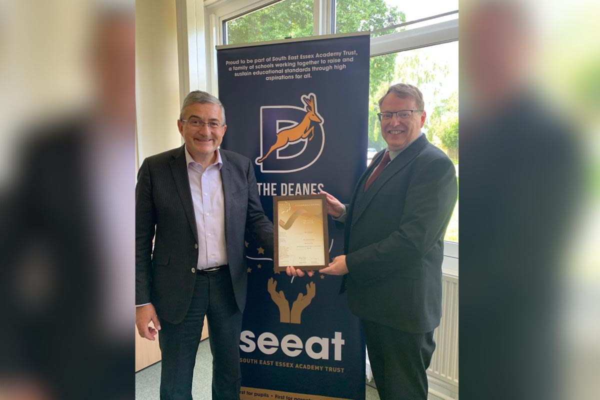 CEO, Andrew Cooper, handing Desi McKeown, headteacher at The Deanes School, his award <i>(Image: South East Essex Academy Trust)</i>