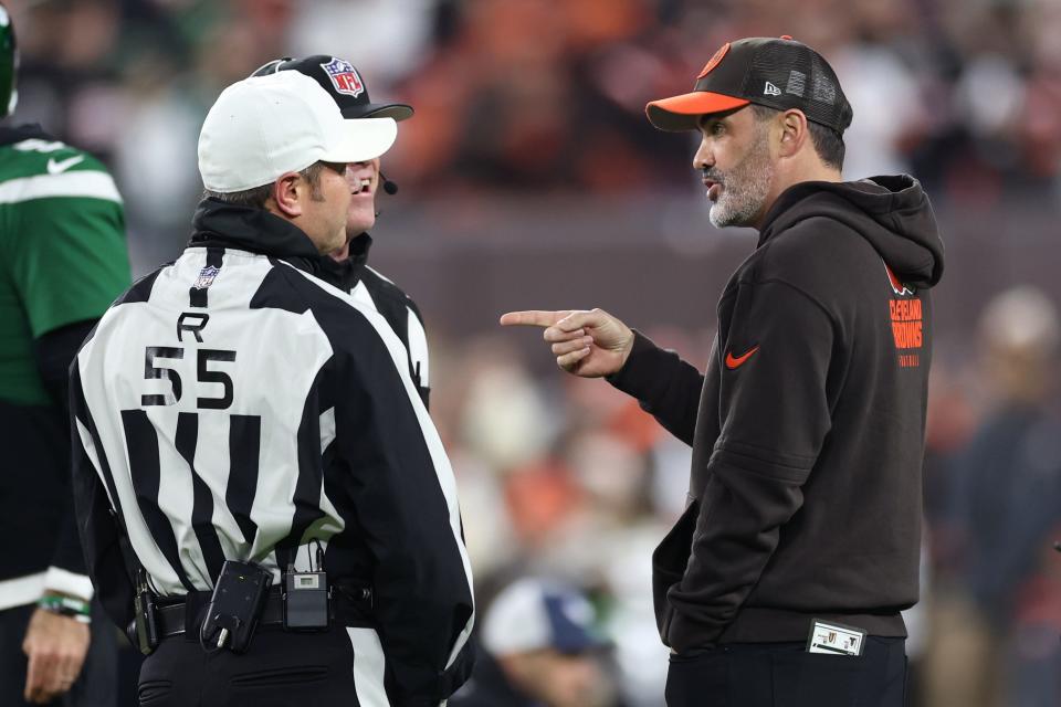 Cleveland Browns coach Kevin Stefanski (right) talks to referee Alex Kemp (55) and down judge Danny Short (rear) before a game against the New York Jets on Dec. 28, 2023, in Cleveland.