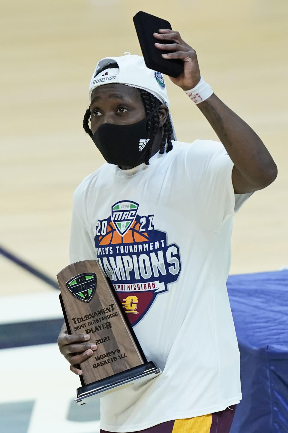 Central Michigan's Micaela Kelly holds the MVP trophy after Central Michigan defeated Bowling Green 77-72 in an NCAA college basketball game in the championship of the Mid-American Conference tournament, Saturday, March 13, 2021, in Cleveland. (AP Photo/Tony Dejak)