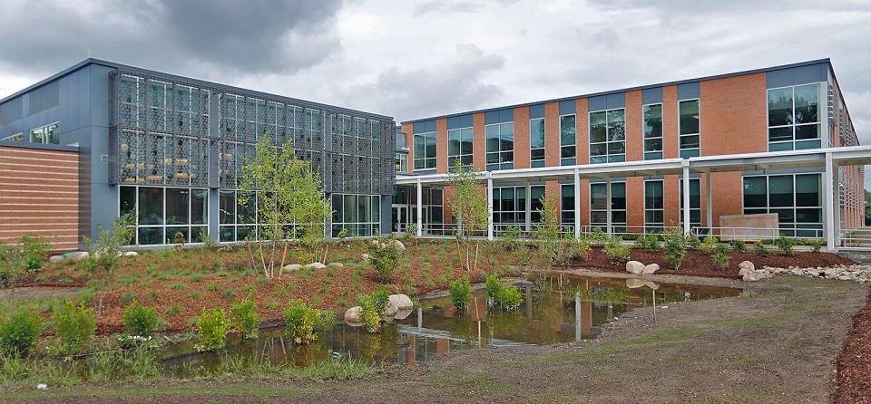 The front entrance to the new South Middle School in Braintree has a small pond area.