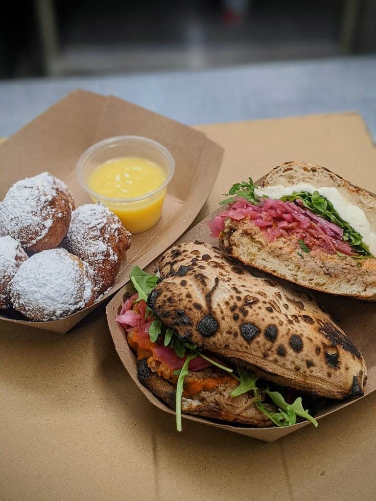 Pictured is the Piri Piri Pulled Pork Panuozzo and Zeppole, Italian donuts, with lemon curd. They are available at Lucky Leopard Pizza at High Horse Bar.
