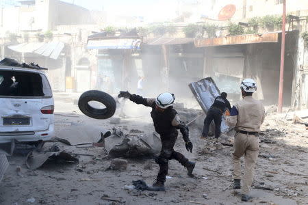 Civil defence members look for survivors after an airstrike on the rebel-held Old Aleppo, Syria April 16, 2016. REUTERS/Abdalrhman Ismail