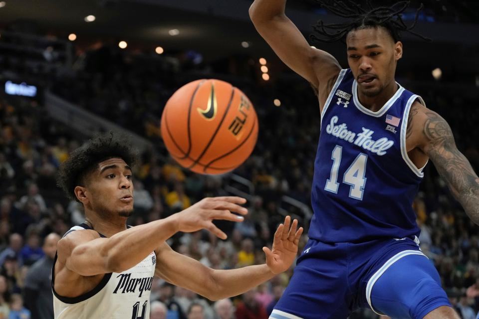 Marquette's Stevie Mitchell passes around Seton Hall's Dre Davis during the first half of an NCAA college basketball game Tuesday, Dec. 27, 2022, in Milwaukee. (AP Photo/Morry Gash)