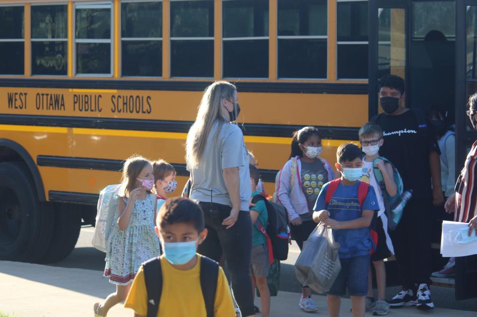 Students arrive for school at Pine Creek Elementary. A new partnership with several nonprofits, businesses and churches in the community is expected to benefit the school by providing additional resources and assistance.