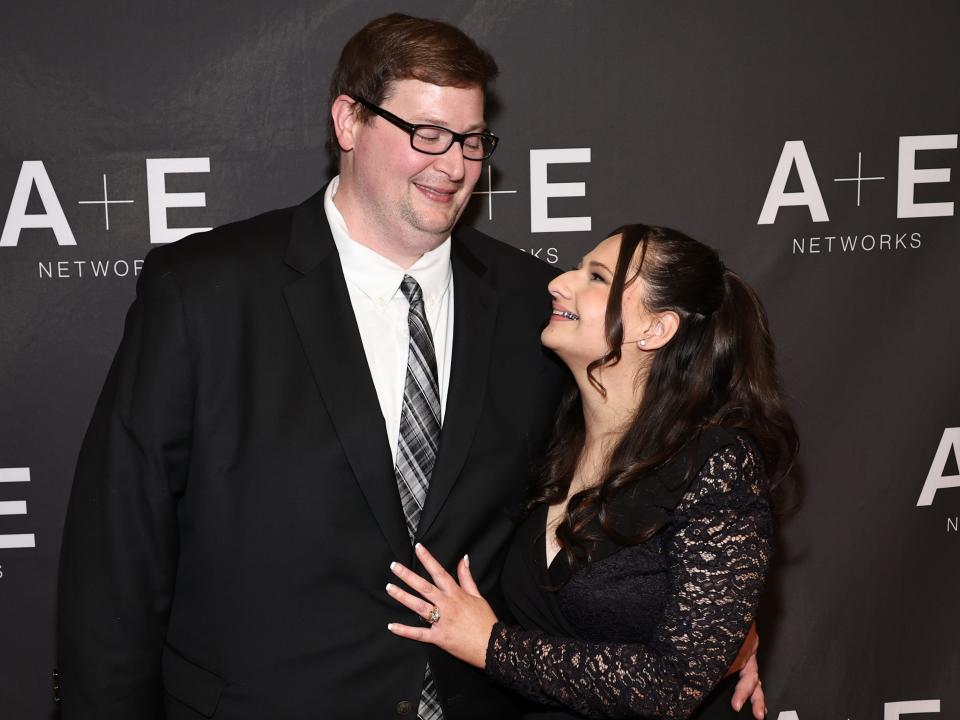 ryan anderson and gypsy rose blanchard-anderson together on the red carpet for her docuseries, smiling and looking at each other while standing closely together