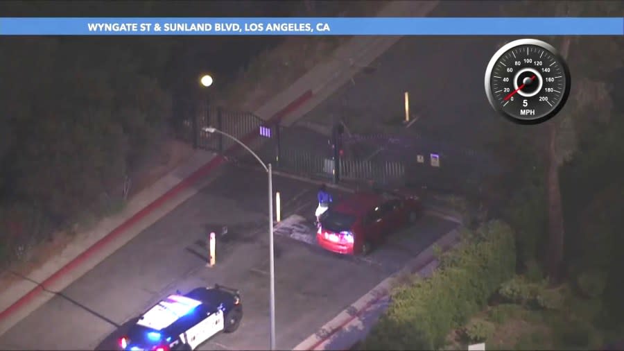 The suspect tried ramming the metal gate of a Sunland apartment complex but failed. He jumped out of the car and ran into the complex. (KTLA)