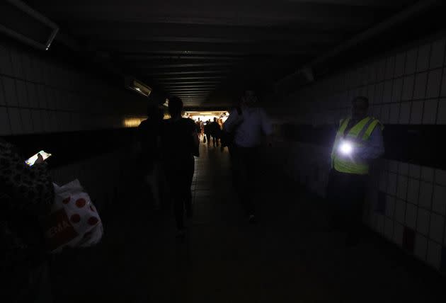 People walk in complete darkness at Clapham Junction station in London during a power cut in 2019. (Photo: Yui Mok - PA Images via Getty Images)