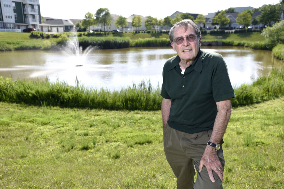 Former Navy frogman Clancy Hatleberg, who was the first person to interact with the Apollo 11 crew when they returned to earth from the moon on July 24, 1969, stands near a pond outside his home Friday, July 11, 2019 in Laurel, Md. He was 25 at the time of the historic mission, and fresh from an underwater demolition team rotation in Vietnam. (AP Photo/Steve Ruark)