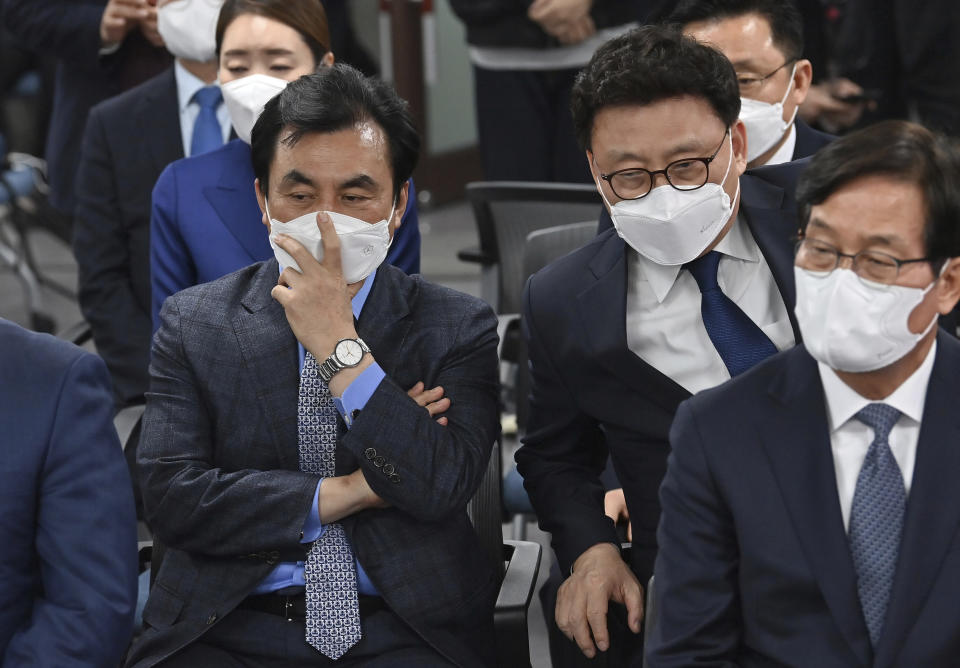 Members of South Korean ruling Democratic Party watch screens showing the result of exit polls of the Seoul mayoral by-election at the party headquarters Wednesday, April 7, 2021, in Seoul, South Korea. (Jung Yeon-je/Pool Photo via AP)