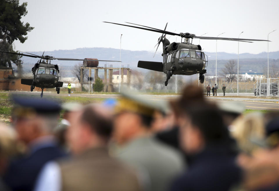 A military helicopter lands at an airbase during an inauguration ceremony in Kocuve, about 85 kilometers (52 miles) south of Tirana, Albania, Monday, March 4, 2024. NATO member Albania inaugurated an international tactic air base on Monday, the Alliance's first one in the Western Balkan region. (AP Photo/Armando Babani)