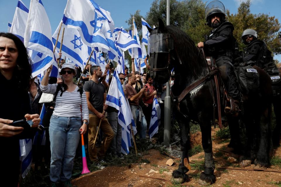 <div class="inline-image__caption"><p>People attend a demonstration after Israeli Prime Minister Benjamin Netanyahu dismissed the defense minister as his nationalist coalition government presses on with its judicial overhaul, in Jerusalem, March 27, 2023. </p></div> <div class="inline-image__credit">REUTERS/Ammar Awad</div>