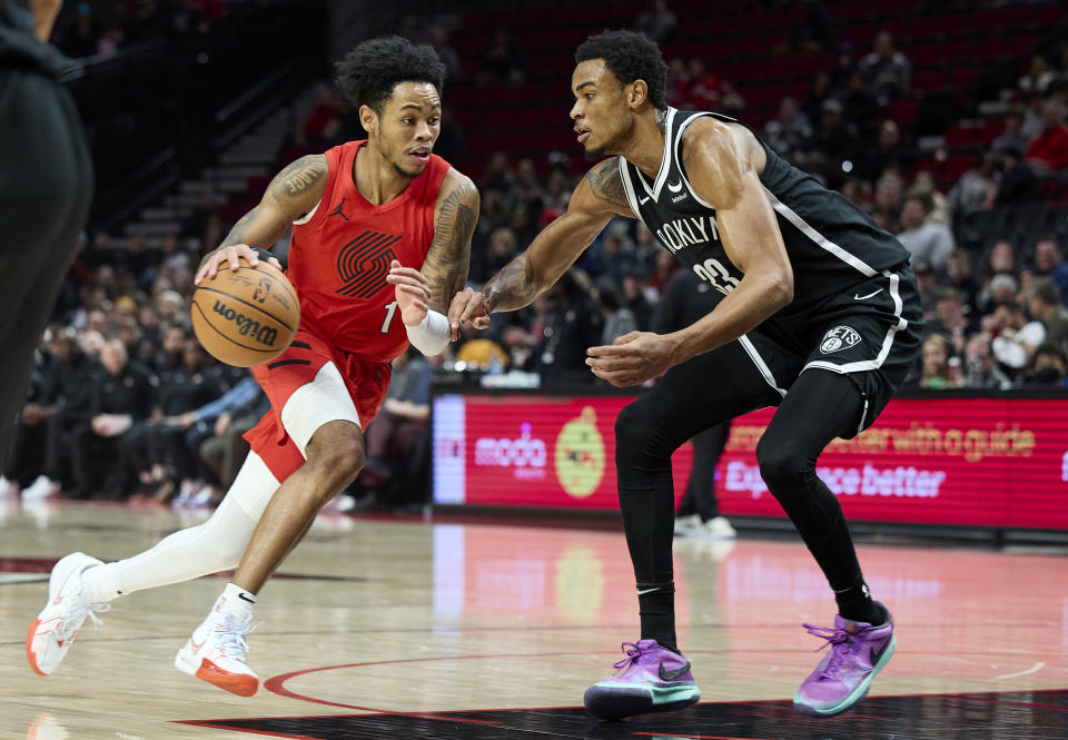 Portland Trail Blazers guard Anfernee Simons, left, drives against Brooklyn Nets center Nic Claxton during the first half of an NBA basketball game in Portland, Ore., Wednesday, Jan. 17, 2024. (AP Photo/Craig Mitchelldyer)