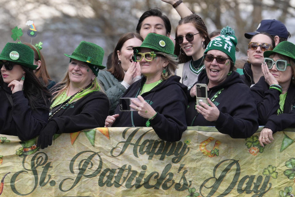 People in costume watch the St. Patrick's Day parade, Sunday, March 17, 2024, in Boston's South Boston neighborhood. (AP Photo/Steven Senne)