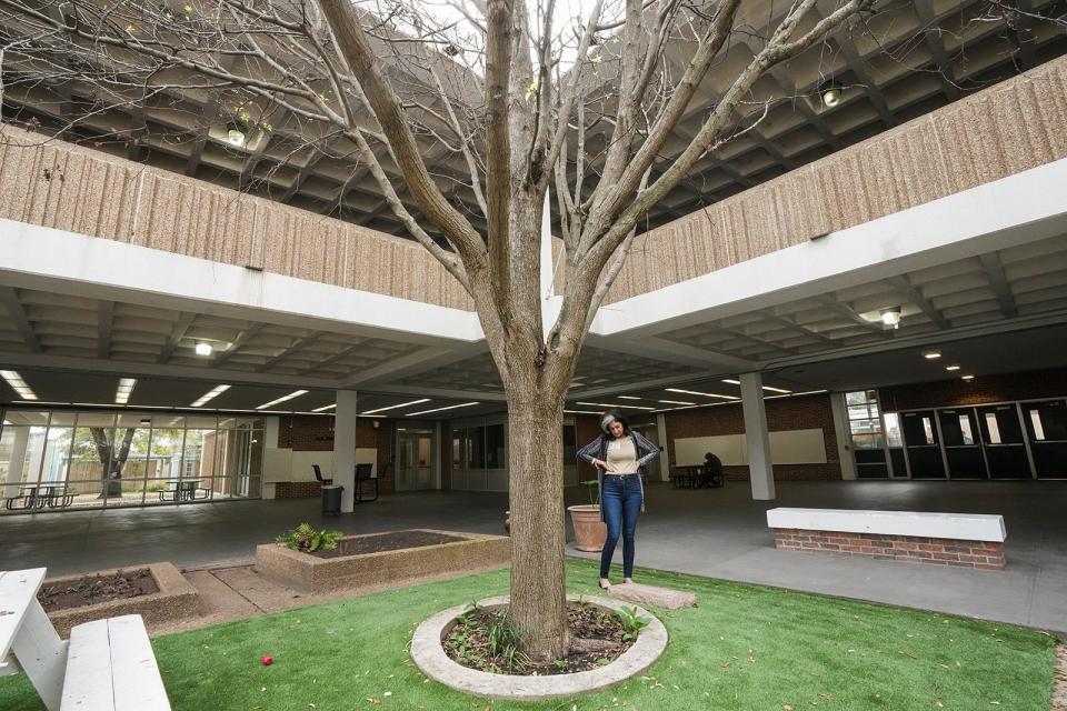 Vanessa Conner visits the memorial tree planted in honor of Ortralla Mosley in the courtyard of Northeast Early College High School Wednesday, March 8, 2023. Conner was Mosley's teacher and was with her as she died. 