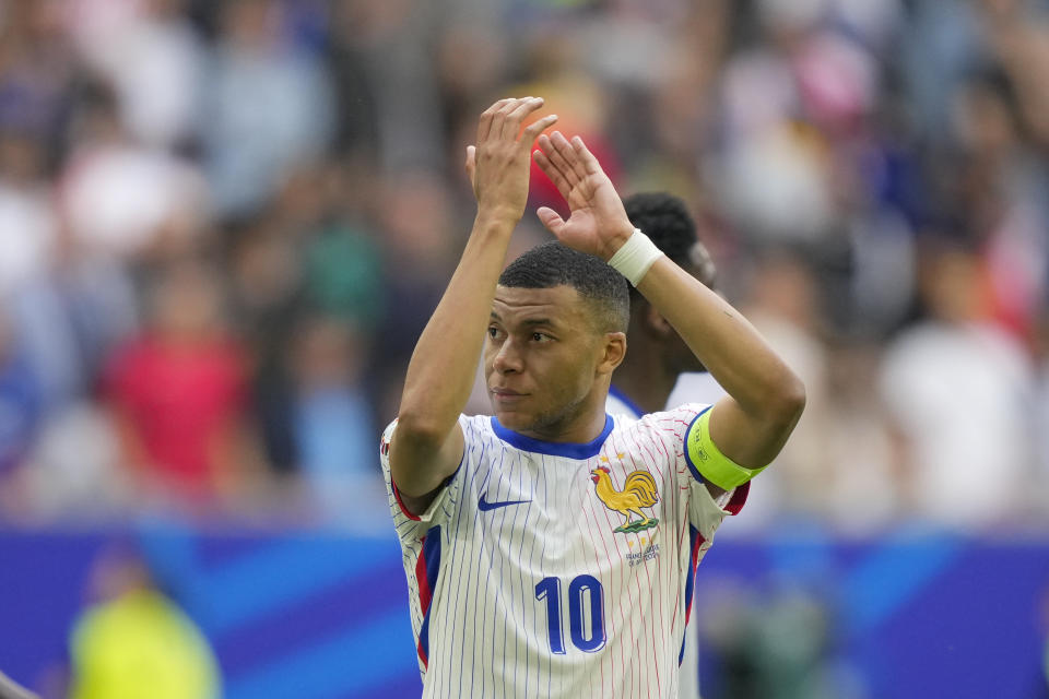 Kylian Mbappe of France applauds to fans after a round of sixteen match between France and Belgium at the Euro 2024 soccer tournament in Duesseldorf, Germany, Monday, July 1, 2024. France won 1-0. (AP Photo/Martin Meissner)