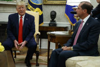 Secretary of Health and Human Services Alex Azar looks on as President Donald Trump talks about a plan to ban most flavored e-cigarettes, in the Oval Office of the White House, Wednesday, Sept. 11, 2019, in Washington. (AP Photo/Evan Vucci)
