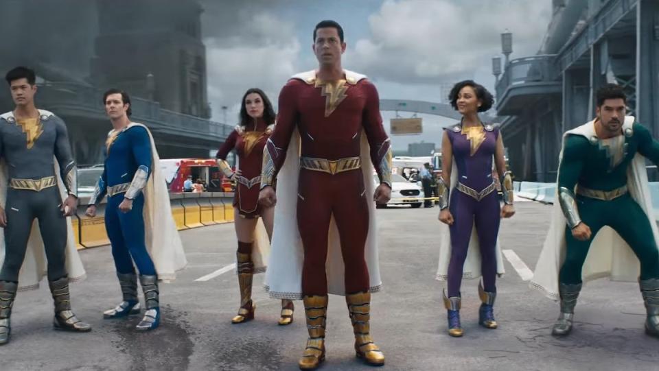 Shazam and his Shazam Family stand together in thier adult superhero form on a birdge in Shazam: Fury of the GOds