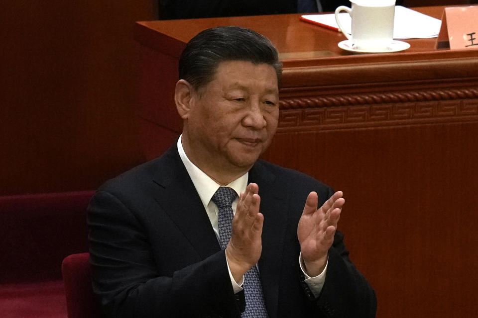 Chinese President Xi Jinping applauds during the opening session of the Chinese People's Political Consultative Conference in the Great Hall of the People in Beijing, Monday, March 4, 2024. (AP Photo/Ng Han Guan)