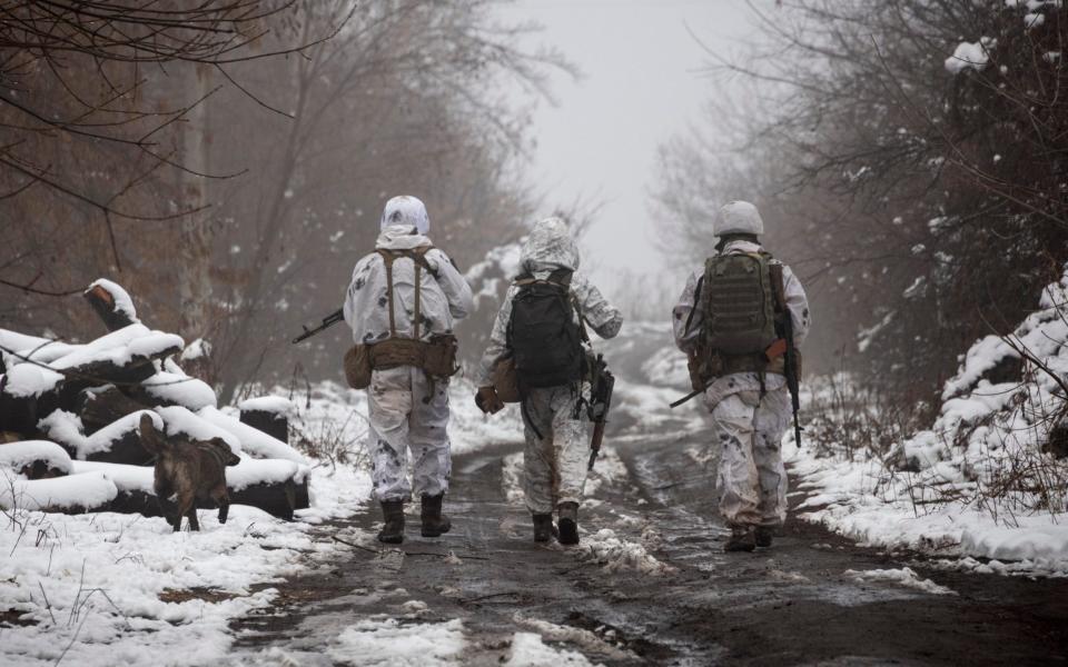 Ukrainian soldiers walks at the line of separation from pro-Russian rebels near Katerinivka, Donetsk region - AP Photo/Andriy Dubchak