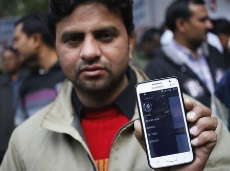 An Uber taxi driver shows an application software in his mobile phone used to track the taxi's location, in New Delhi December 12, 2014. REUTERS/Anindito Mukherjee