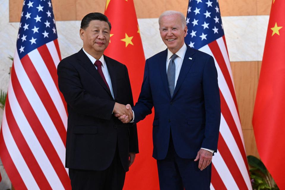 US President Joe Biden (R) and China's President Xi Jinping (L) shakes hands as they meet on the sidelines of the G20 Summit in Nusa Dua on the Indonesian resort island of Bali on November 14, 2022.