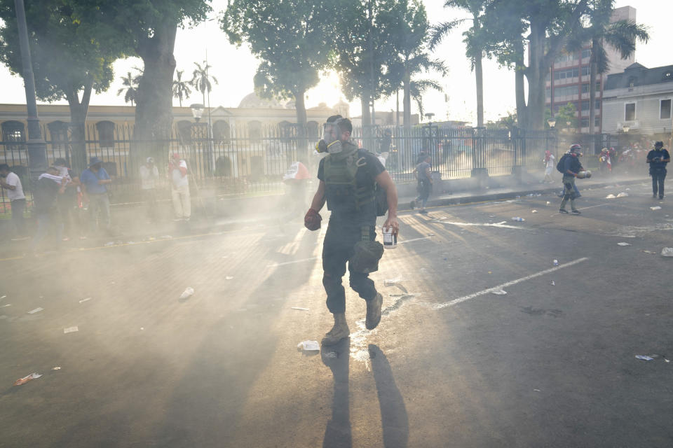 Anti-government protesters face off against the police in Lima, Peru, Thursday, Jan. 19, 2023. Protesters are seeking immediate elections, the resignation of President Dina Boluarte, the release from prison of ousted President Pedro Castillo and justice for protesters killed in clashes with police. (AP Photo/Martin Mejia)