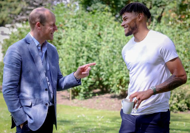 <p>Kensington Palace / Andy Parsons</p> Prince William with soccer player Tyrone Mings who is an advocate for his Homewards project