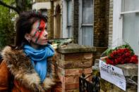 With face paint and flowers, fans worldwide mourn Bowie