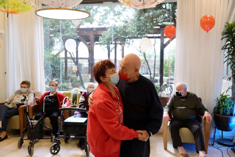 Residents of an assisted living facility dance after receiving their booster shots of the vaccination against the coronavirus disease (COVID-19), in Netanya