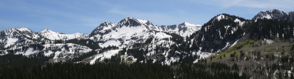 This Tuesday, June 11, 2019, photo shows the snow covered Wasatch Range near Salt Lake City. The summer's melting snowpack is creating raging rivers that are running high, fast and icy cold. The state's snowpack this winter was about 150 percent higher than the historical average and double the previous year, which was the driest on record dating back to 1874, said Brian McInerney, hydrologist for the National Weather Service in Salt Lake City. About twice as much snow remains on the mountain peaks as normal because cold and wet conditions in late May added to snowpack. (AP Photo/Rick Bowmer)