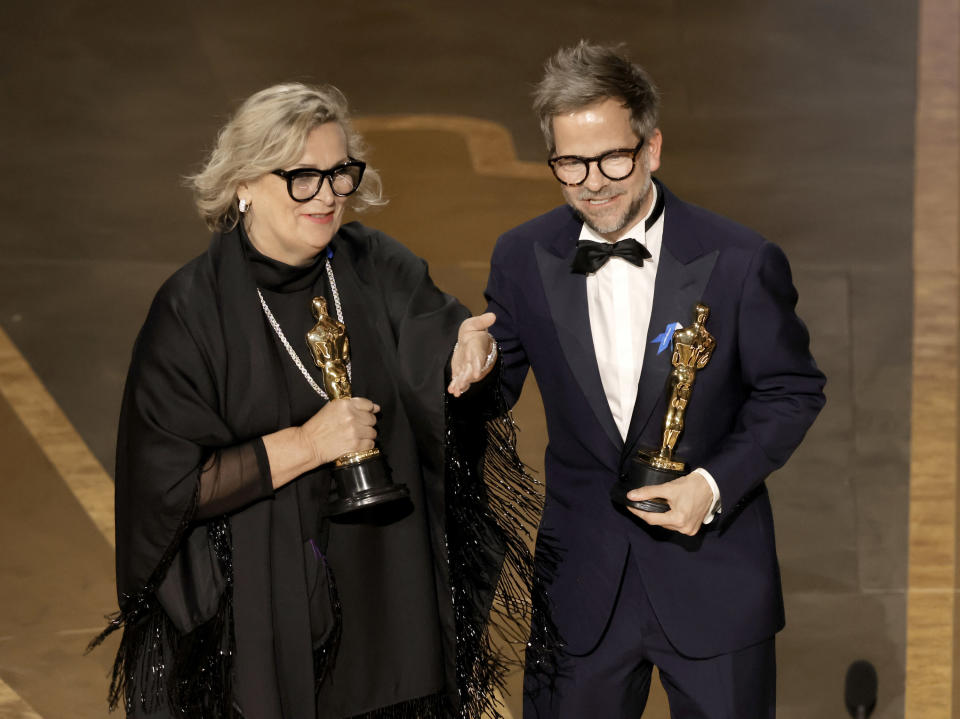 Ernestine Hipper and Christian M. Goldbeck accept the Best Production Design award for All Quiet on the Western Front during the Academy Awards on March 12.