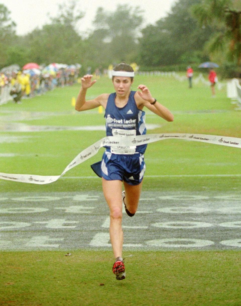 Erin Sullivan, from Jericho, Vt., crosses the finish line to win the 1997 high school cross country championship in Lake Buena Vista, Fla., Saturday, Dec. 13, 1997.