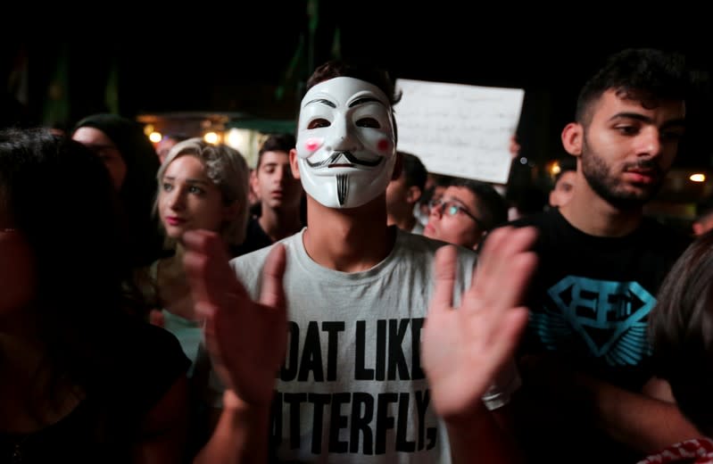 A demonstrator wears a mask during an anti-government protest in the southern city of Nabatiyeh