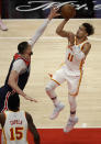 Atlanta Hawks' Trae Young, right, shoots over Washington Wizards' Alex Len during the first half of an NBA basketball game Monday, May 10, 2021, in Atlanta. (AP Photo/Ben Margot)