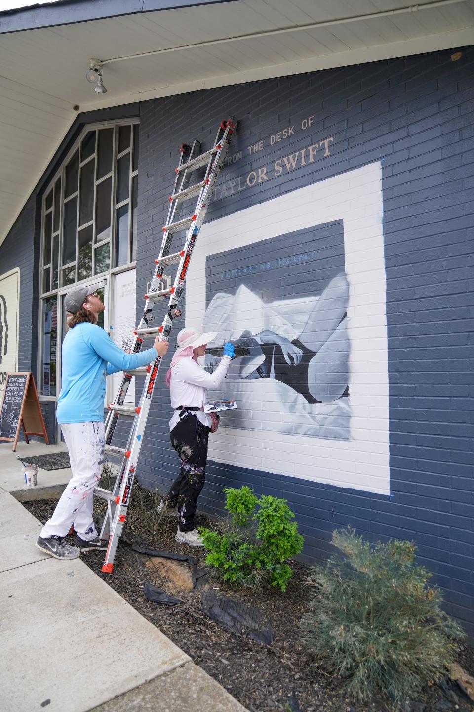 Muralists paint the album cover of Taylor Swift's "The Tortured Poets Department" to celebrate the new release.