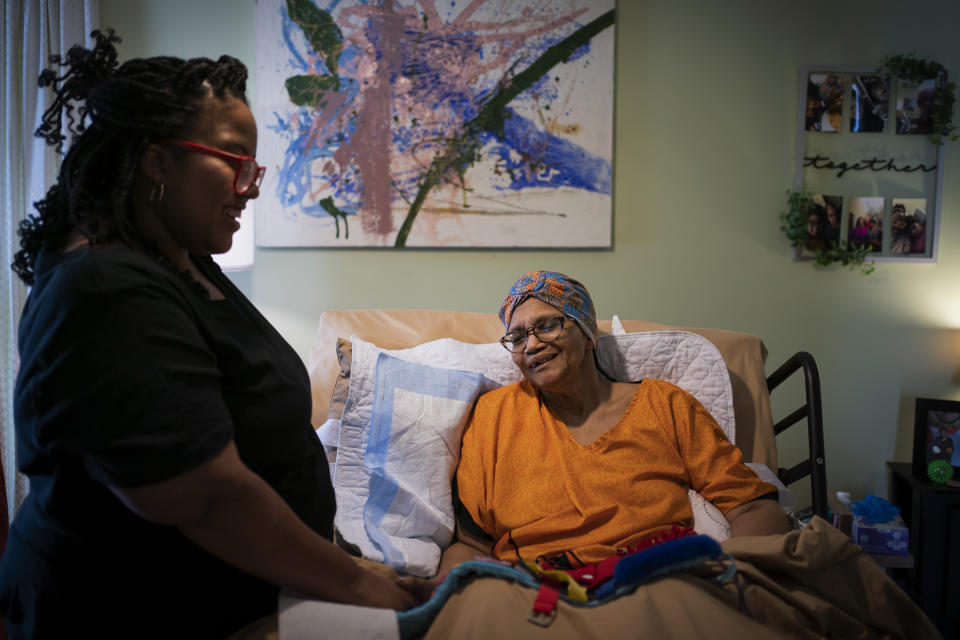 Constance Guthrie smiles at her daughter, Jessica, during a musical session where Jessica sings gospel music, a favorite of Constance, in Fredericksburg, Va., on Tuesday, Sept. 20, 2022. “Music brightens my mom. She would sing no matter if she was on key or not.” (AP Photo/Wong Maye-E)