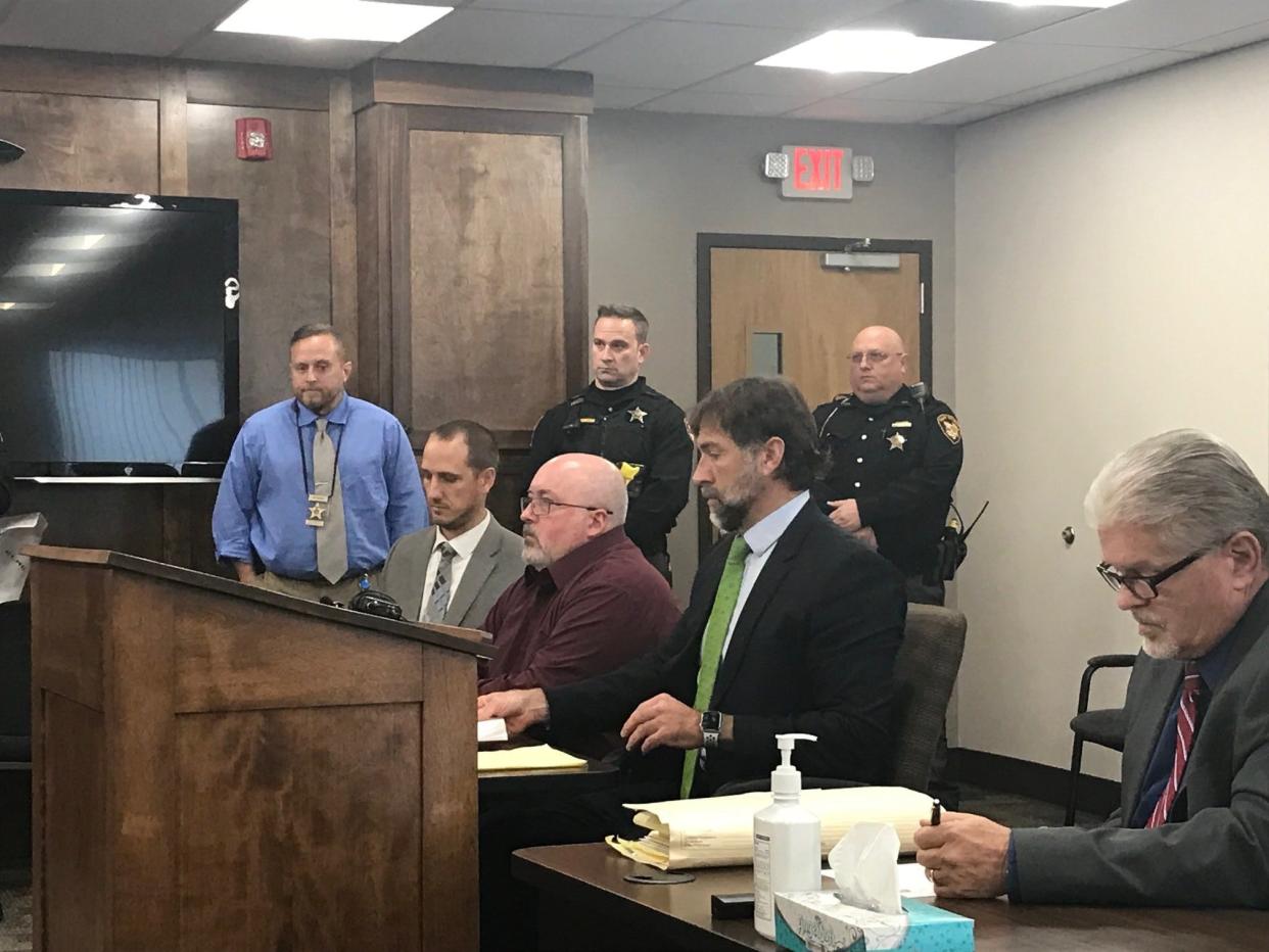 Mark D. Cooper, center, in dark red shirt, was arraigned Wednesday on three felony charges in connection with the September 2019 death of an inmate who had been forcibly subdued by officers at the Richland County Jail. Right of Cooper are his attorney, James Mayer III; and S. Forrest Thompson, a special prosecutor appointed by Richland County Prosecutor Gay Bishop to investigate the case.