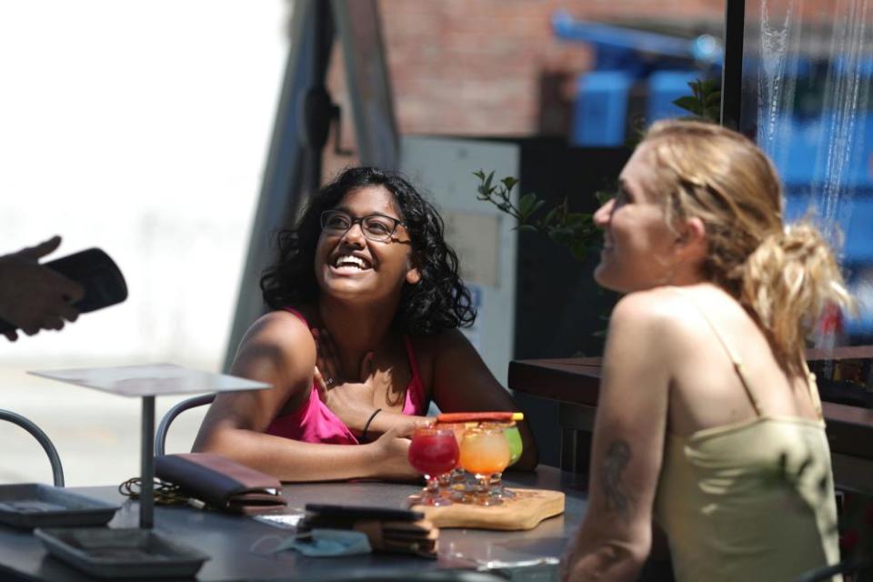 Upekshila Wickett, 26, and Valerie Grant, 26, drink margeritas at a restaurant in Santa Monica.