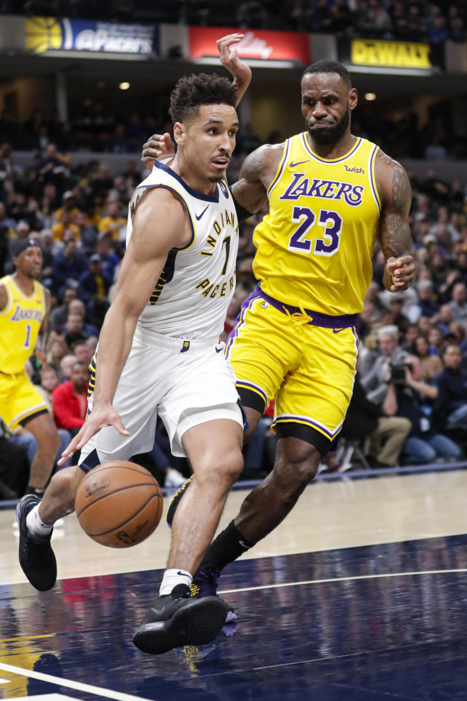 Indiana Pacers guard Malcolm Brogdon (7) drives on Los Angeles Lakers forward LeBron James (23) during the second half of an NBA basketball game in Indianapolis, Tuesday, Dec. 17, 2019. The Pacers defeated the Lakers 105-102. (AP Photo/Michael Conroy)