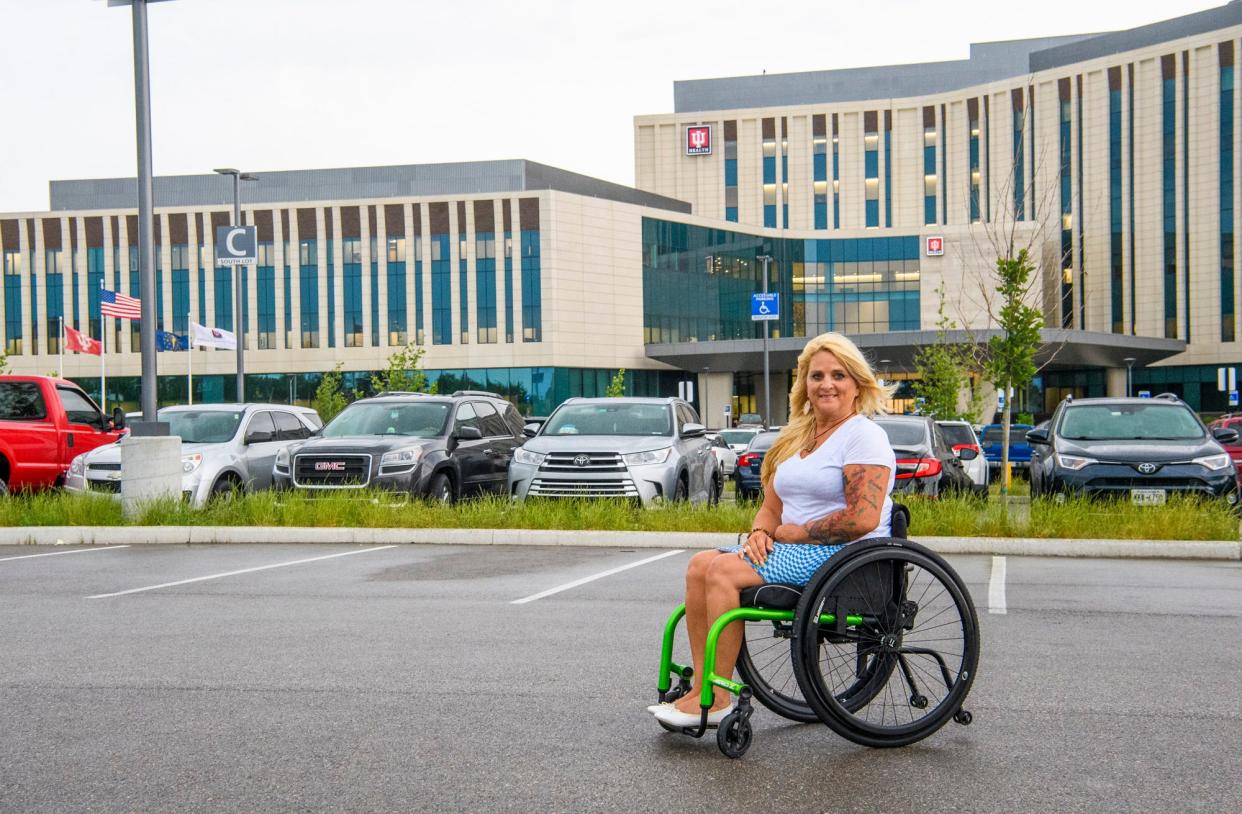 Lesamarie Hacker poses in front of IU Health Hospital Bloomington on Friday, June 17, 2022. Hacker in late spring filed a complaint with the city over accessibility challenges at the hospital. She said Friday hospital officials have now addressed most of her concerns.