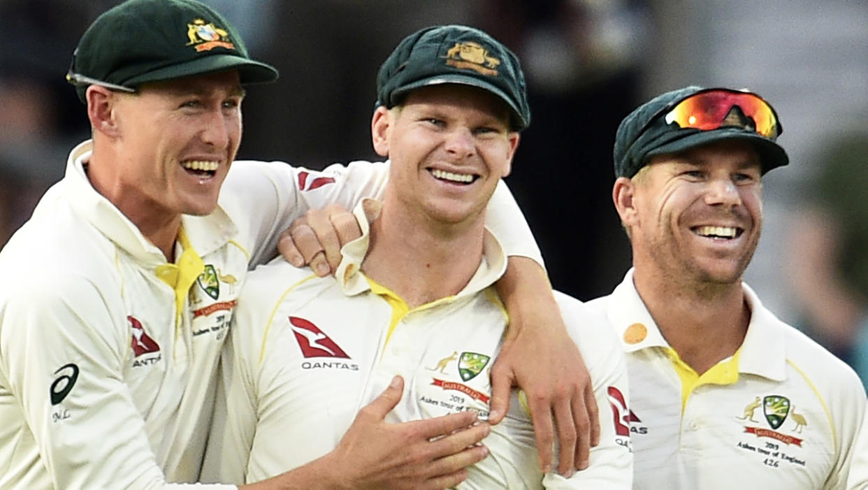 Steve Smith (pictured middle) is congratulated after taking a catch.