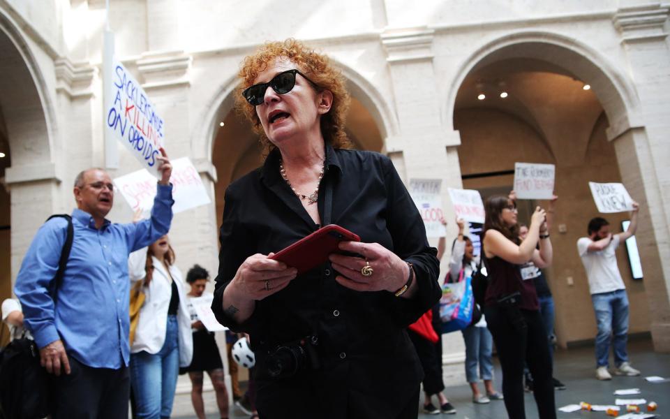 Nan Goldin leads a demonstration at the Harvard Art Museums in Cambridge, MA, to protest the benefactor of the Sackler Art Museum - Boston Globe 